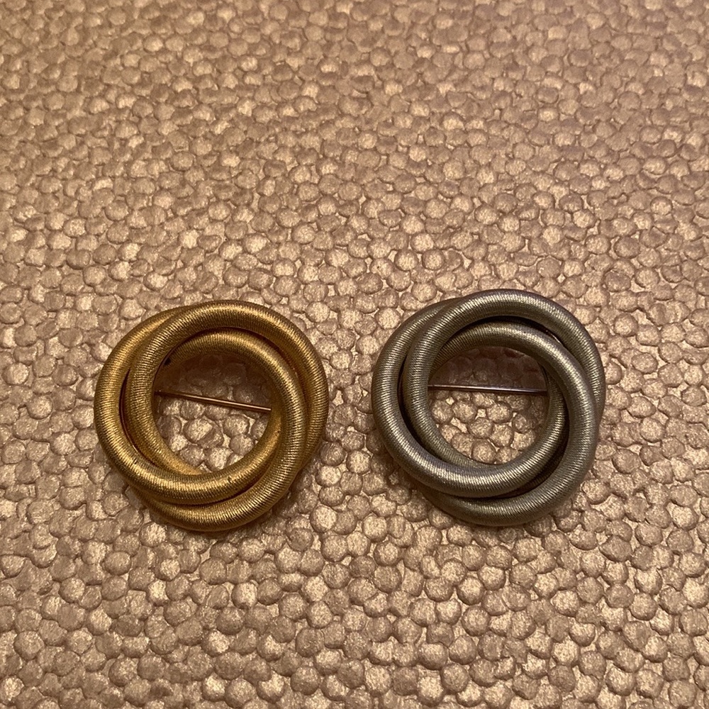 Two signed  vintage Sarah Coventry pins. One silver and one gold.